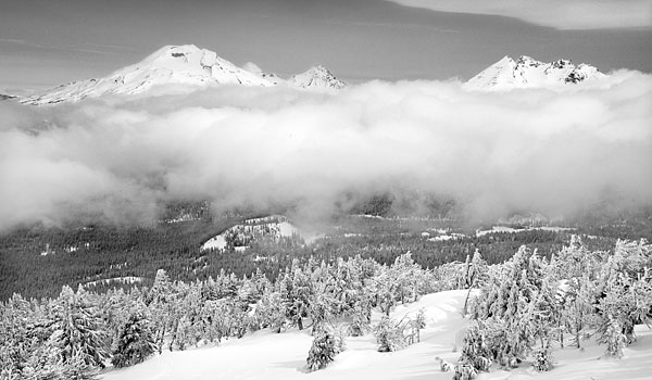 Cascade Volcanoes rise above low clouds, South Sister and Broken Top from Mt. Bachelor, Cascade Mountains, Oregon Photograph by David Whitten